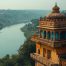 Indian city buildings alongside a winding river