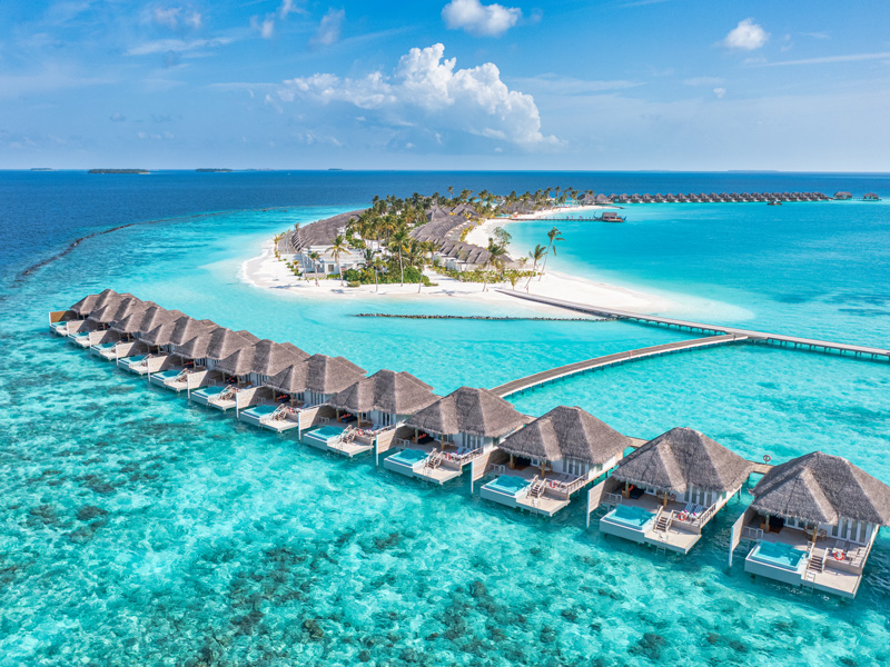 picturesque vision of the Maldives with turquoise water and individual cabins