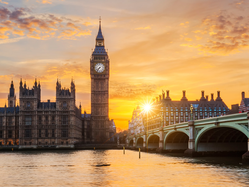 Sunset over Big Ben and the houses of parliament in London with the River Thames in the forefront